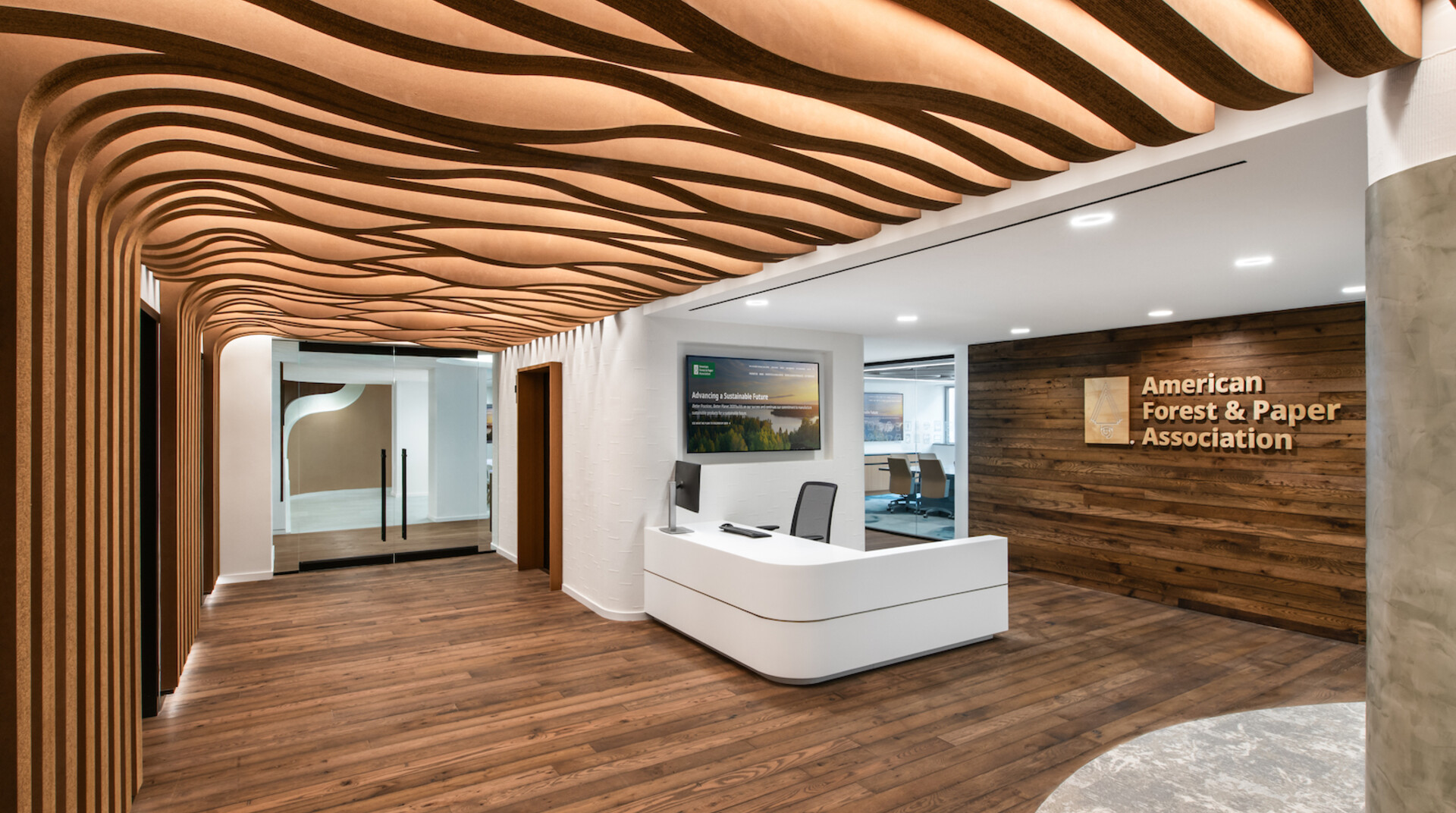 The reception area of AF&PA's office features corrugated millwork and hardwood floors