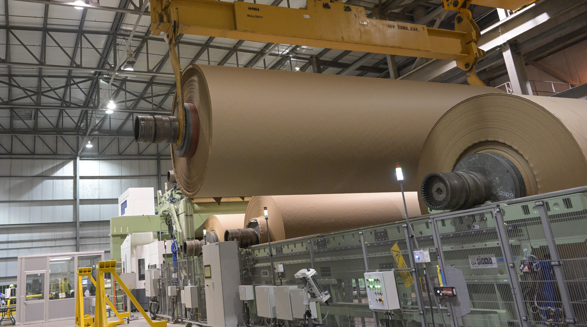 Kraft paper rolls being moved in a Domtar paper mill