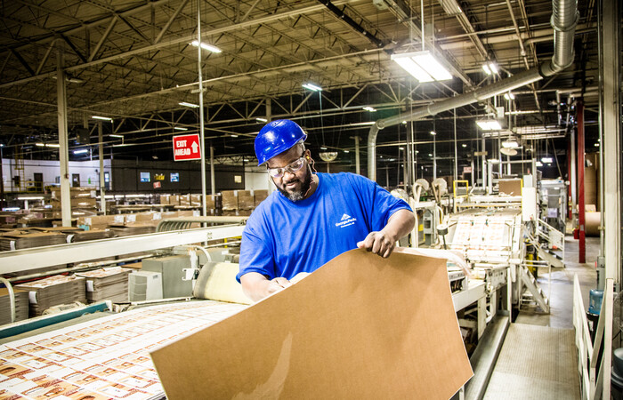 A man inspecting paper packaging