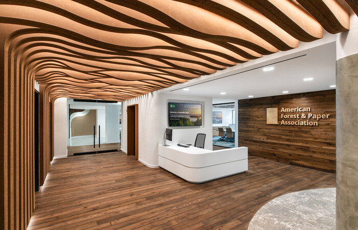 The reception area of AF&PA's office features corrugated millwork and hardwood floors