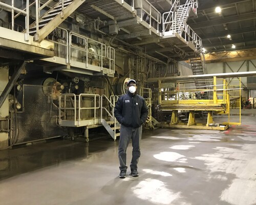 Tyrone Hussey standing inside a paper mill.