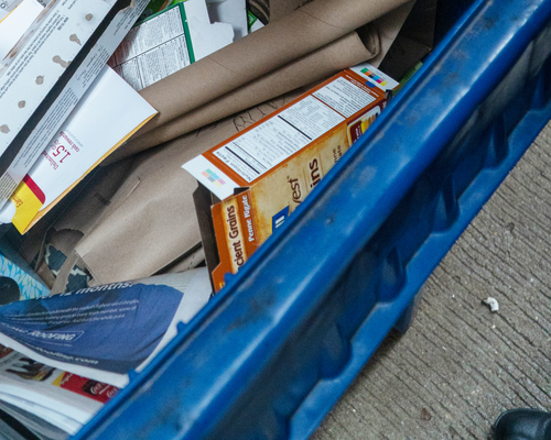 A mix of paper recyclables in a recycling bin