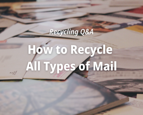 Different types of mail including window envelopes, magazines and cards on a table.