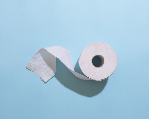 A roll of toilet paper slightly unraveling.