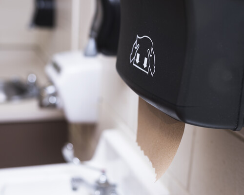 A brown paper towel in a dispenser