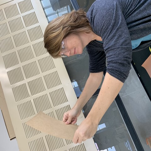 Lisa Schultz inspecting a piece of paper 