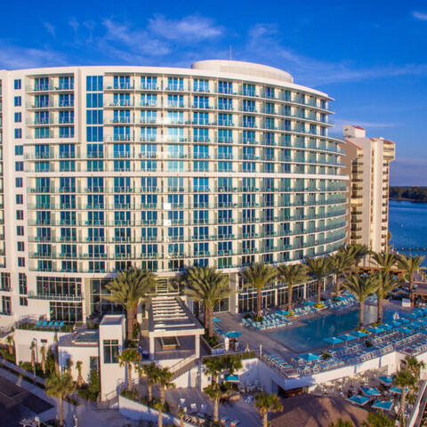 The outside for the Opal Sands Resort features multiple stories for windows viewing the ocean. 