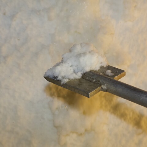 A metal flat shovel and a white paper pulp